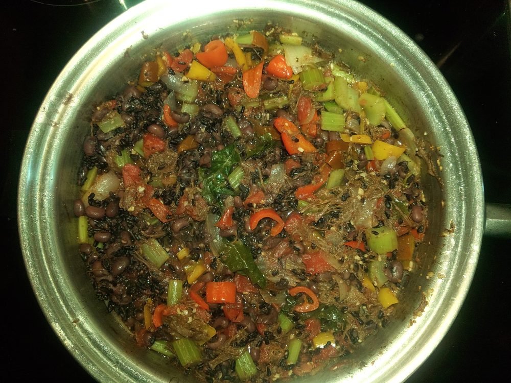 A pot of bison broth simmering with vegetables and herbs
